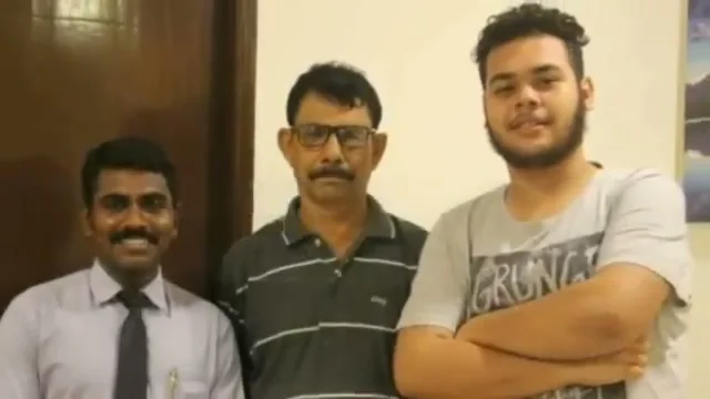 Sevagan Satheesh standing with two clients